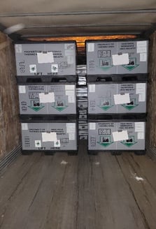 A group of boxes in a room

Description automatically generated