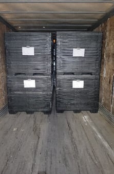 A stack of black crates

Description automatically generated